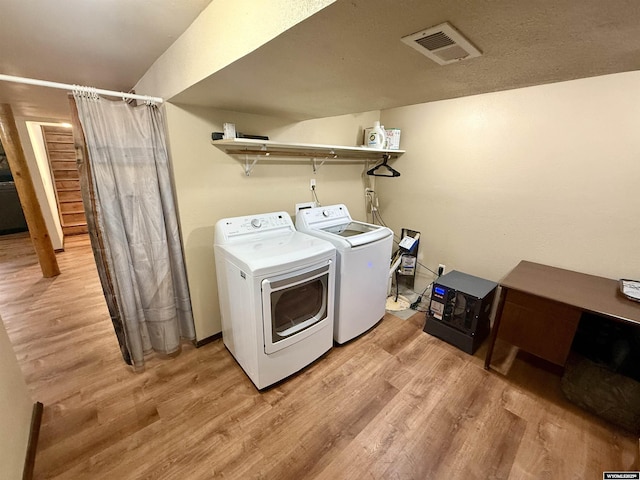 17512 US Highway 14, Carlile, WY 82721 - washroom with washing machine and clothes dryer and light wood-type flooring
