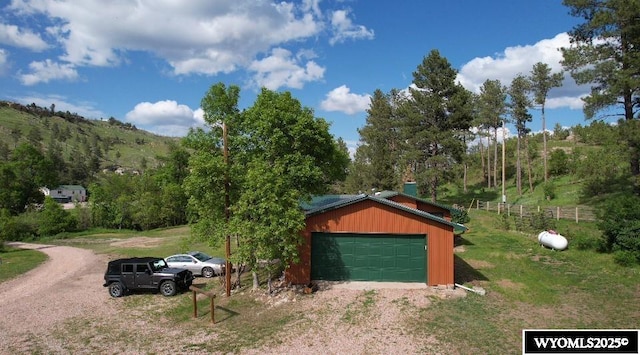 17512 US Highway 14, Carlile, WY 82721 - garage featuring dirt driveway and a view of trees