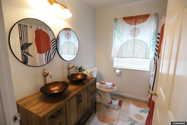 108 Tamari Dr, Buffalo, WY 82834 - full bathroom with vanity, toilet, tile patterned floors, and baseboards