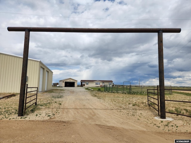 2 Freight Wagon Rd, Farson, WY 82932 - view of dirt / gravel driveway featuring a view of rural / pastoral area, a gated entry, and a pole building