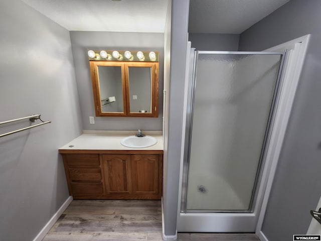 2 Freight Wagon Rd, Farson, WY 82932 - bathroom featuring a shower stall, wood finished floors, and vanity