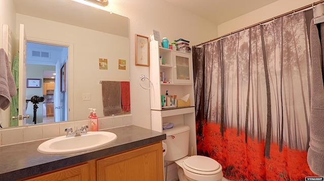 1141 Meadow Ln, Douglas, WY 82633 - bathroom with toilet, vanity, and curtained shower