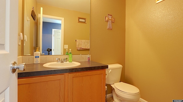 1141 Meadow Ln, Douglas, WY 82633 - half bath featuring vanity, toilet, and a textured wall