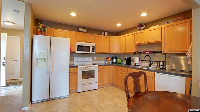 1141 Meadow Ln, Douglas, WY 82633 - kitchen featuring white appliances, a sink, dark countertops, light brown cabinets, and recessed lighting