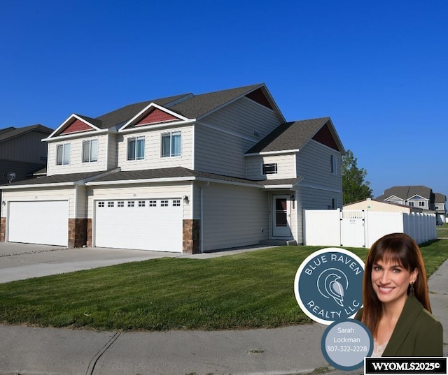 70A 28th St, Wheatland, WY 82201 - view of front of house with driveway, an attached garage, stone siding, and a gate