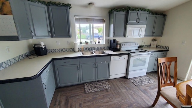 307 3rd St, Chugwater, WY 82210 - kitchen with white appliances, a sink, gray cabinetry, and light countertops
