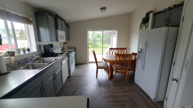 307 3rd St, Chugwater, WY 82210 - kitchen with white appliances, vaulted ceiling, a sink, and gray cabinets