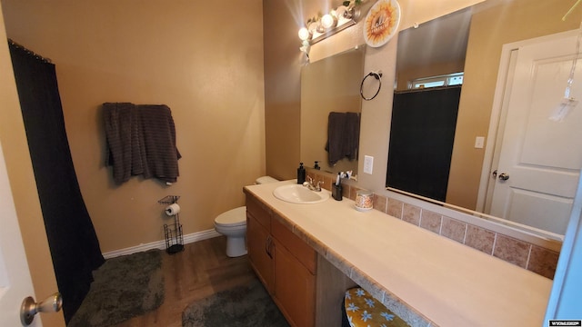 307 3rd St, Chugwater, WY 82210 - bathroom featuring toilet, vanity, baseboards, and wood finished floors