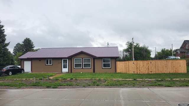 307 3rd St, Chugwater, WY 82210 - ranch-style home with an attached garage and metal roof