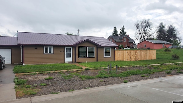 307 3rd St, Chugwater, WY 82210 - ranch-style house with metal roof and a garage