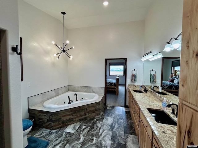 207 Eagle Dr, Greybull, WY 82426 - bathroom featuring ensuite bath, a bath, marble finish flooring, double vanity, and toilet