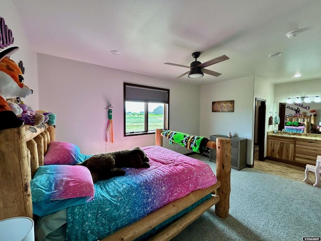 207 Eagle Dr, Greybull, WY 82426 - bedroom featuring light carpet, ceiling fan, and ensuite bath