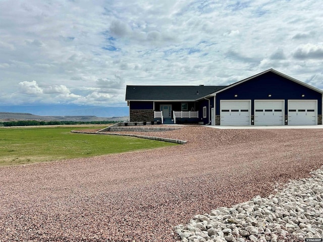 207 Eagle Dr, Greybull, WY 82426 - ranch-style house with driveway, an attached garage, and a front lawn