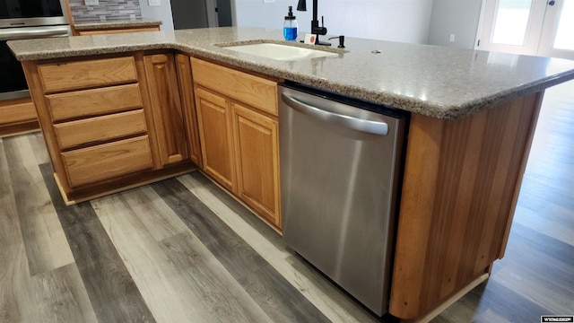 8 Amy Ln, Rock Springs, WY 82901 - kitchen featuring appliances with stainless steel finishes, a sink, light wood-style floors, and light stone counters