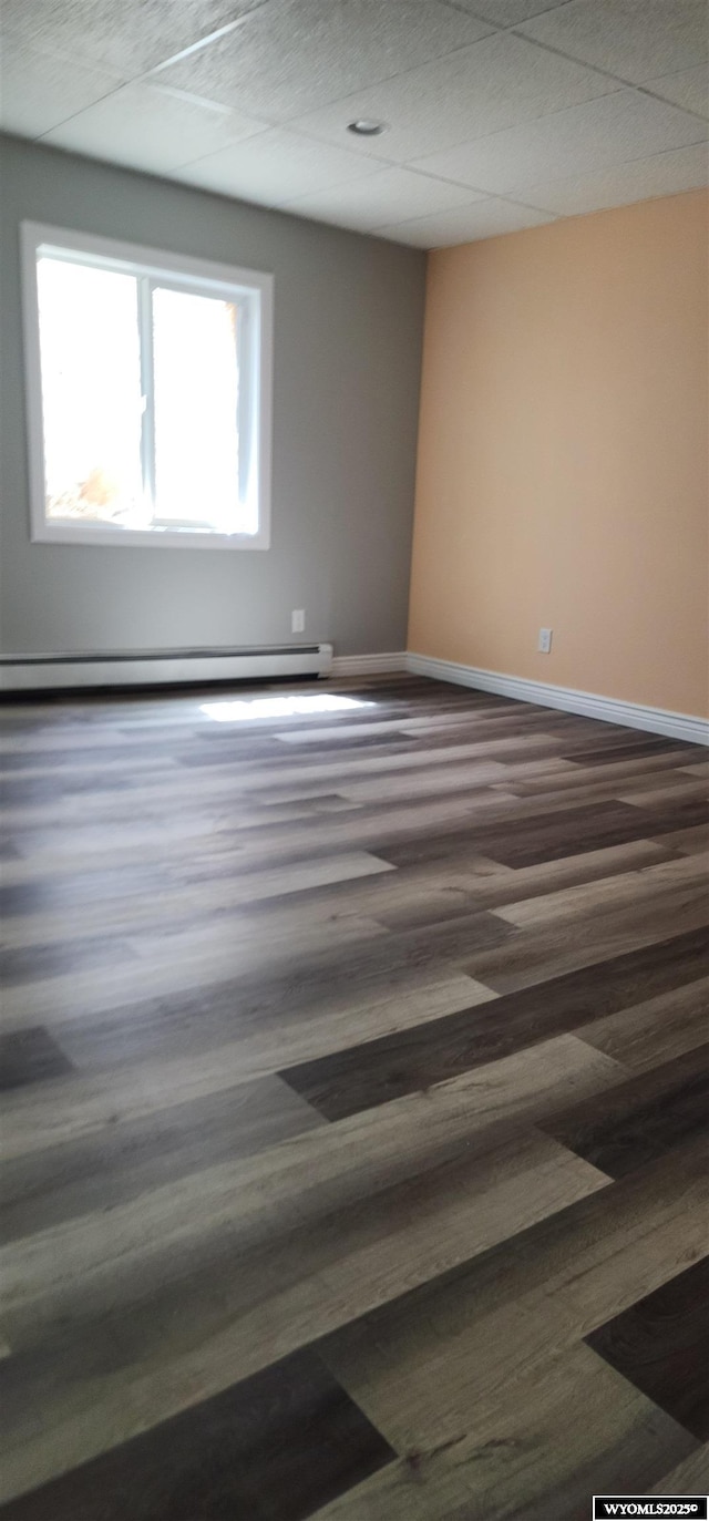 8 Amy Ln, Rock Springs, WY 82901 - spare room featuring dark wood-style floors, a baseboard radiator, and baseboards