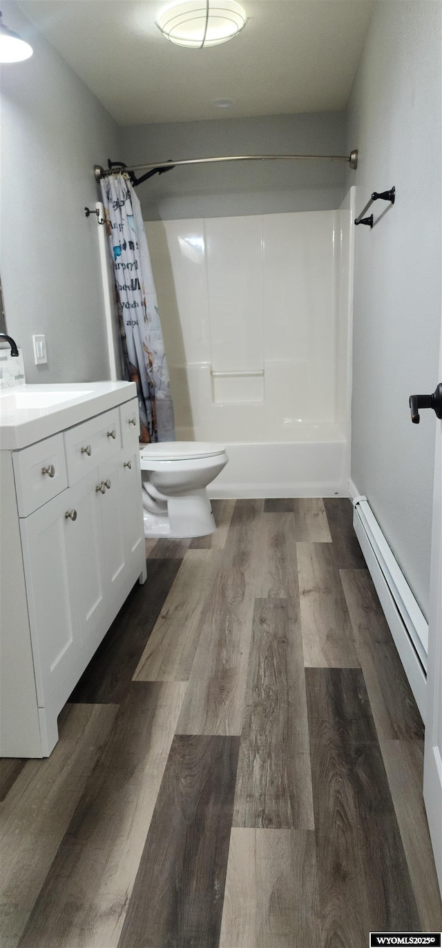 8 Amy Ln, Rock Springs, WY 82901 - bathroom featuring toilet, vanity, wood finished floors, and a baseboard radiator