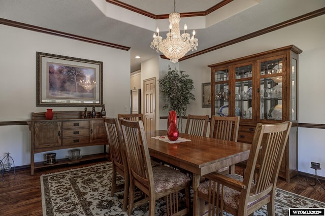 2867 Ardon Ln, Casper, WY 82609 - dining room with a raised ceiling, a chandelier, dark wood finished floors, baseboards, and crown molding