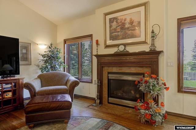 2867 Ardon Ln, Casper, WY 82609 - living area with wood finished floors, baseboards, a fireplace, and vaulted ceiling