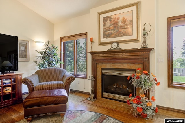 2867 Ardon Ln, Casper, WY 82609 - living area with wood finished floors, a tiled fireplace, and baseboards