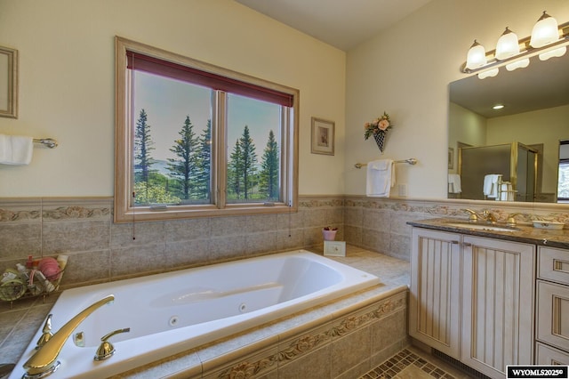 2867 Ardon Ln, Casper, WY 82609 - bathroom featuring vanity, a whirlpool tub, a stall shower, and wainscoting