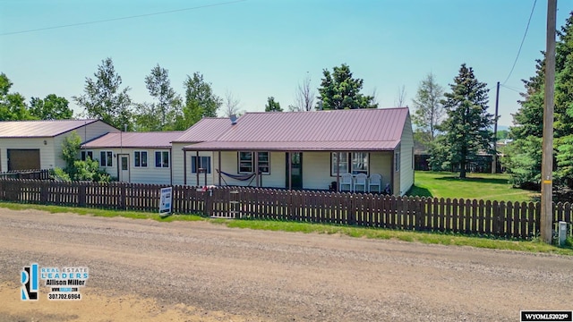 7549 Taxiway, Casper, WY 82604 - ranch-style home featuring a porch, metal roof, and a fenced front yard
