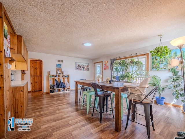 7549 Taxiway, Casper, WY 82604 - dining room with light wood-style floors, a textured ceiling, healthy amount of natural light, and baseboards