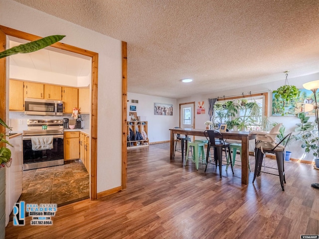 7549 Taxiway, Casper, WY 82604 - dining room with a textured ceiling, wood finished floors, and baseboards