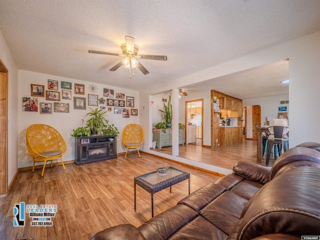 7549 Taxiway, Casper, WY 82604 - living room with a ceiling fan, light wood-type flooring, a textured ceiling, and baseboards