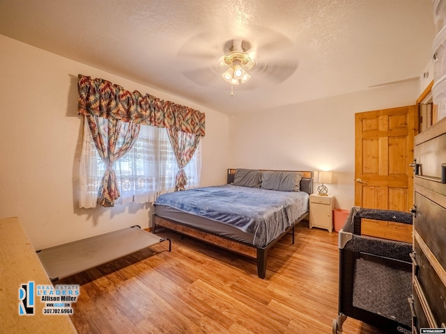 7549 Taxiway, Casper, WY 82604 - bedroom featuring light wood-type flooring, a textured ceiling, and ceiling fan