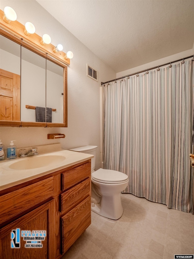 7549 Taxiway, Casper, WY 82604 - bathroom featuring tile patterned floors, vanity, and toilet
