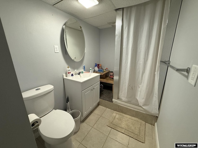 210 N 5th St W, Riverton, WY 82501 - full bath featuring vanity, toilet, tile patterned flooring, and a shower with shower curtain