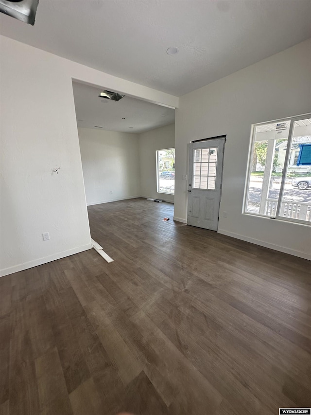409 B St, Rock Springs, WY 82901 - unfurnished living room featuring dark wood-type flooring and baseboards