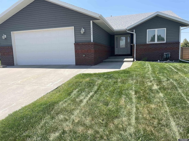 4924 Mountain Way, Casper, WY 82601 - single story home with brick siding, an attached garage, a front lawn, concrete driveway, and a shingled roof