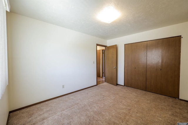 1301 Overland Dr, Rock Springs, WY 82901 - unfurnished bedroom with light carpet, a closet, and a textured ceiling