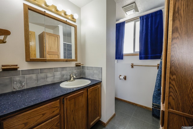 1301 Overland Dr, Rock Springs, WY 82901 - bathroom featuring vanity and decorative backsplash