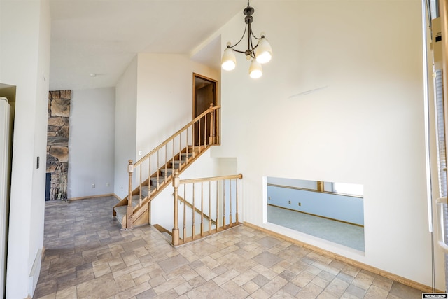 1301 Overland Dr, Rock Springs, WY 82901 - entryway with stone finish flooring, a chandelier, stairs, and a fireplace