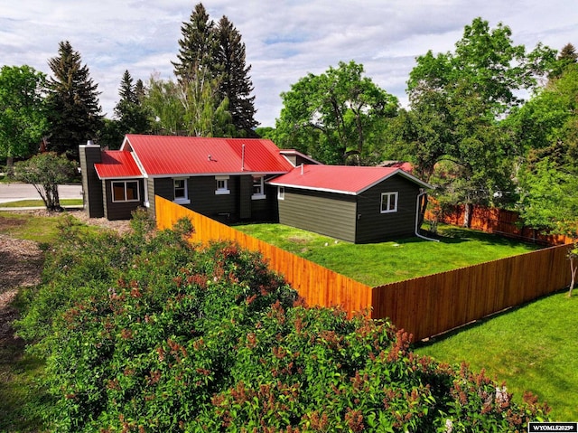 210 Custer St, Lander, WY 82520 - rear view of house with a fenced backyard, a metal roof, and a chimney