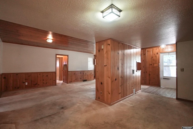 1339 S Mitchell St, Casper, WY 82601 - carpeted spare room featuring wooden walls, a textured ceiling, and wainscoting