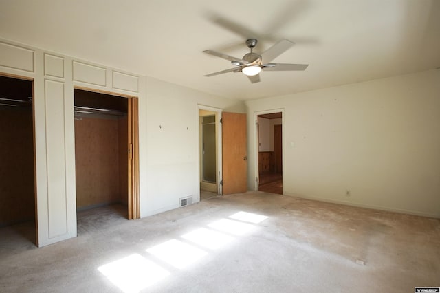 1339 S Mitchell St, Casper, WY 82601 - unfurnished bedroom featuring light carpet, two closets, and ceiling fan