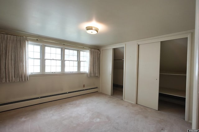 1339 S Mitchell St, Casper, WY 82601 - unfurnished bedroom with a baseboard heating unit, multiple closets, and light carpet