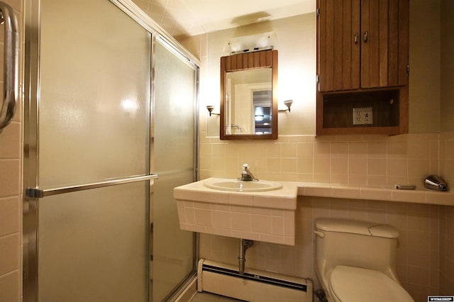 1339 S Mitchell St, Casper, WY 82601 - full bath with a baseboard radiator, tile walls, a shower stall, and backsplash