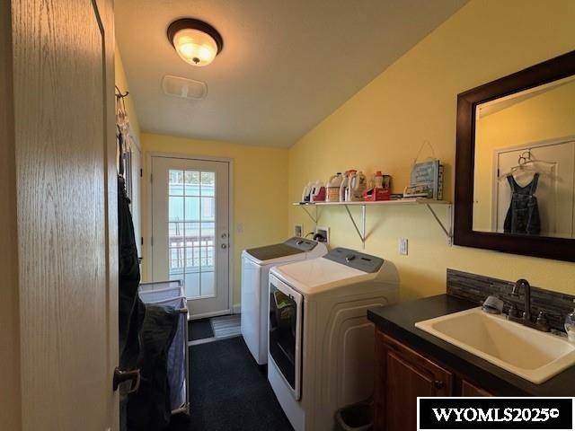 309 Susie Ave, Diamondville, WY 83116 - laundry room with washer and dryer and dark carpet