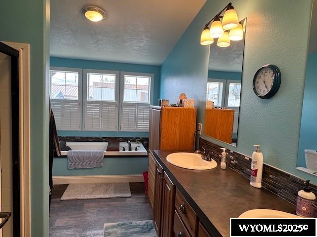 309 Susie Ave, Diamondville, WY 83116 - bathroom with a garden tub, plenty of natural light, and double vanity