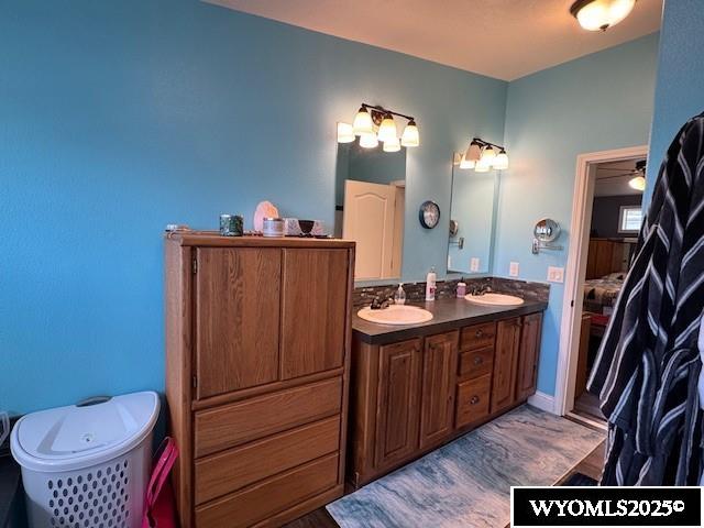 309 Susie Ave, Diamondville, WY 83116 - full bath with double vanity, a bathtub, and connected bathroom