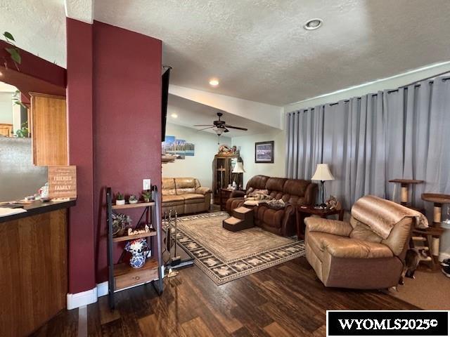 309 Susie Ave, Diamondville, WY 83116 - living room featuring ceiling fan, a textured ceiling, dark wood-type flooring, and recessed lighting