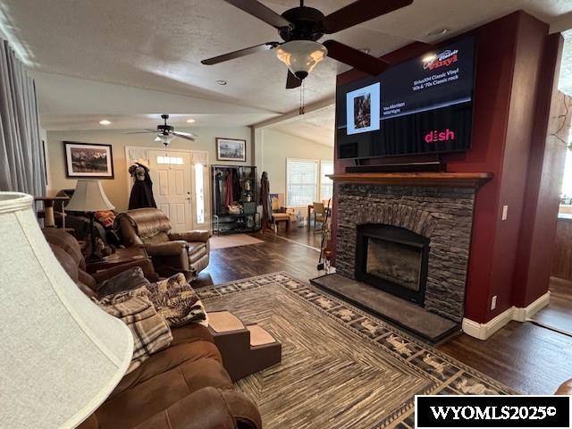 309 Susie Ave, Diamondville, WY 83116 - living area with a ceiling fan, vaulted ceiling, wood finished floors, a fireplace, and recessed lighting