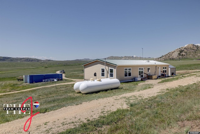 67 Monument Creek Rd, Hanna, WY 82327 - rear view of property with a mountain view, a view of countryside, and a pool