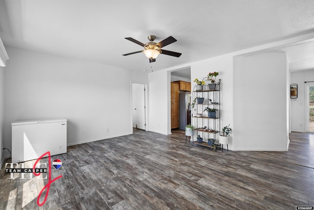 67 Monument Creek Rd, Hanna, WY 82327 - unfurnished living room featuring ceiling fan and dark wood-style floors