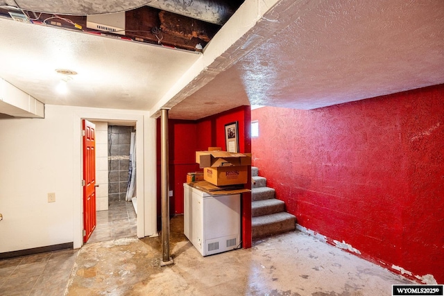 1534 Spaulding St, Sheridan, WY 82801 - finished basement with stairs, a textured ceiling, and fridge