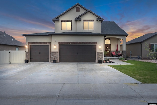 3308 Brickyard Ave, Rock Springs, WY 82901 - view of front facade featuring stucco siding, stone siding, concrete driveway, and a porch
